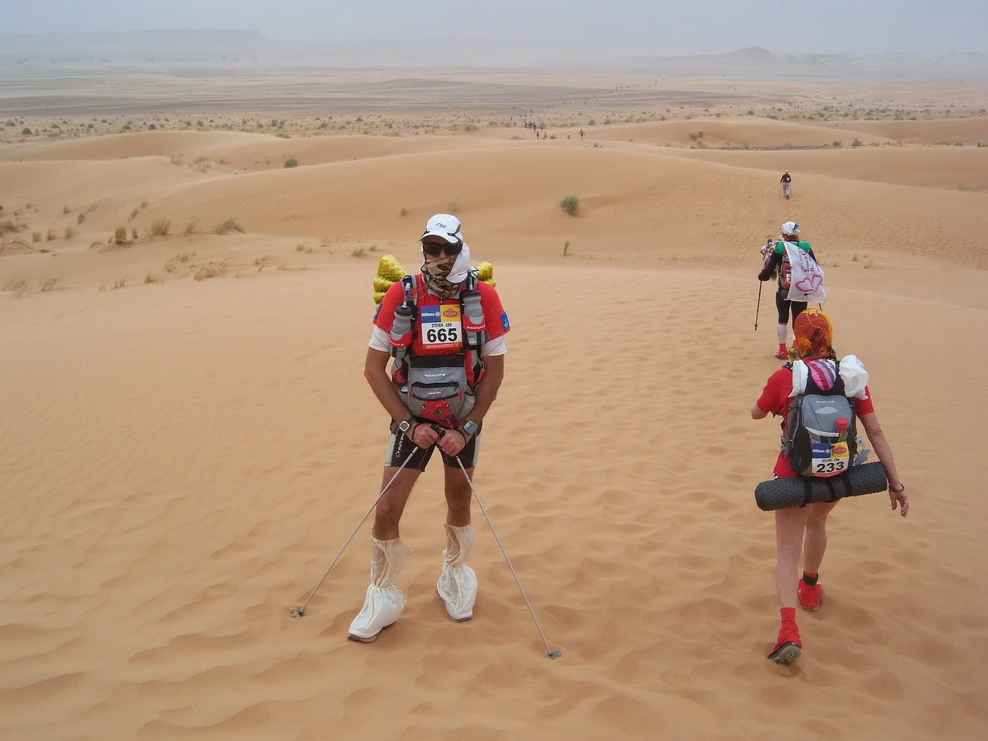 Ultramarathon runners crossing Sahara dunes during Morocco's April desert race