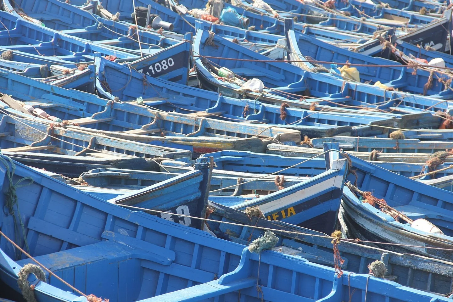 Blue fishing boats in Essaouira harbour on Morocco's windy Atlantic coast in April